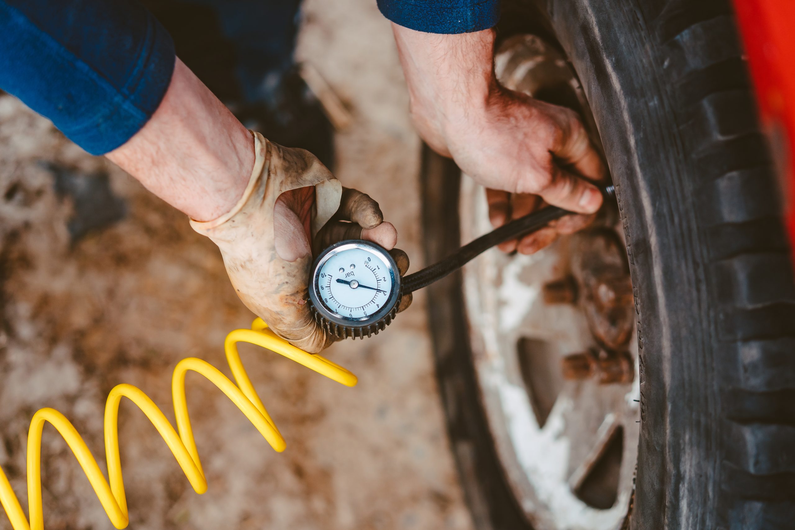 A man pumps air wheel with a compressor
